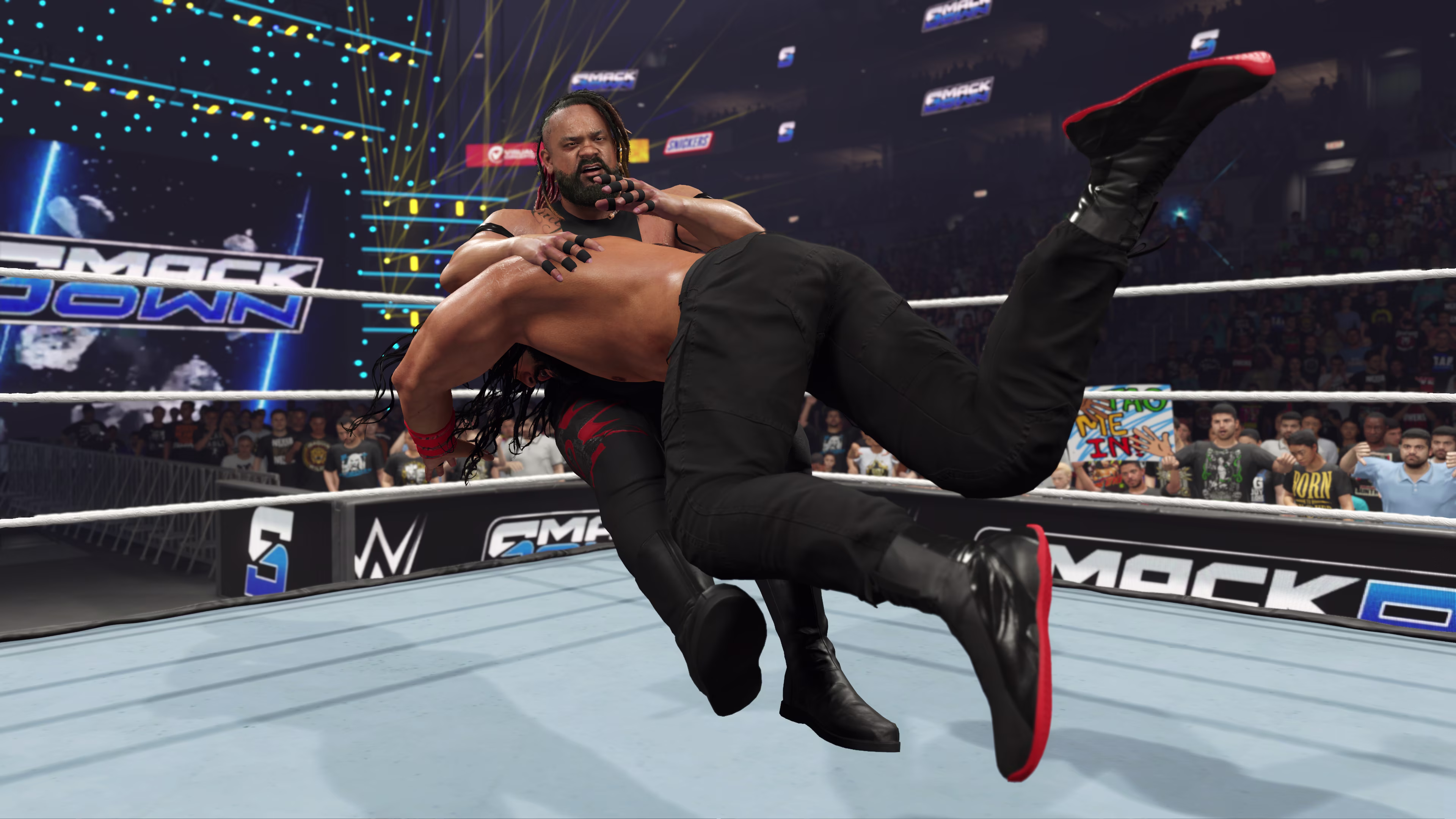 Roman Reigns spears Jacob Fatu on Friday Night Smack Down in WWE 2K25